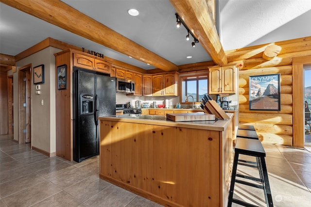 kitchen featuring kitchen peninsula, rustic walls, appliances with stainless steel finishes, and track lighting