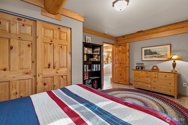 bedroom featuring a closet and light tile patterned flooring