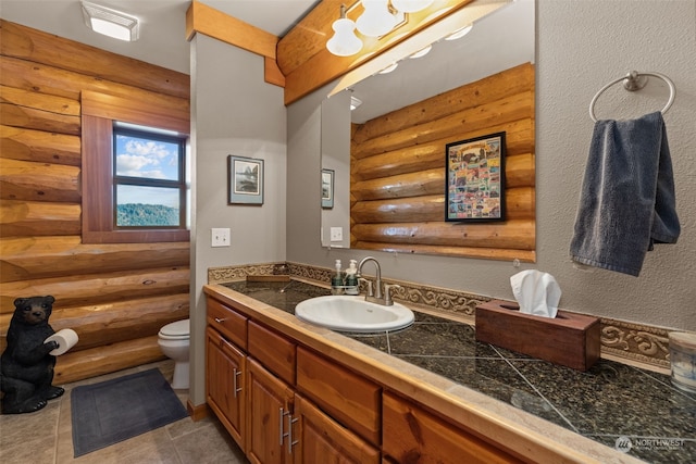 bathroom with log walls, vanity, and toilet