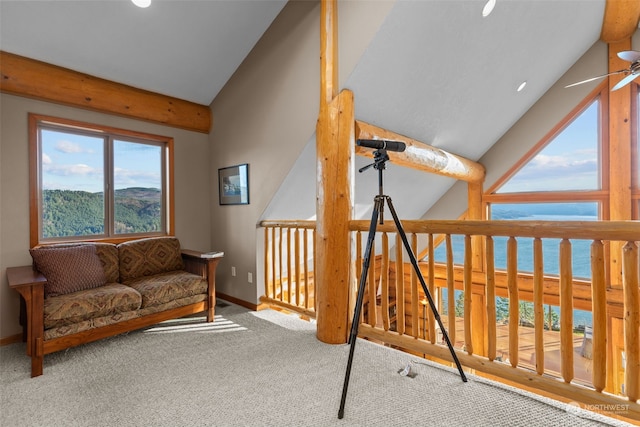 living area featuring carpet floors, a water view, and vaulted ceiling