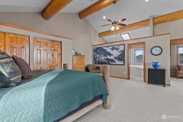 bedroom featuring beam ceiling, multiple closets, light carpet, and ceiling fan