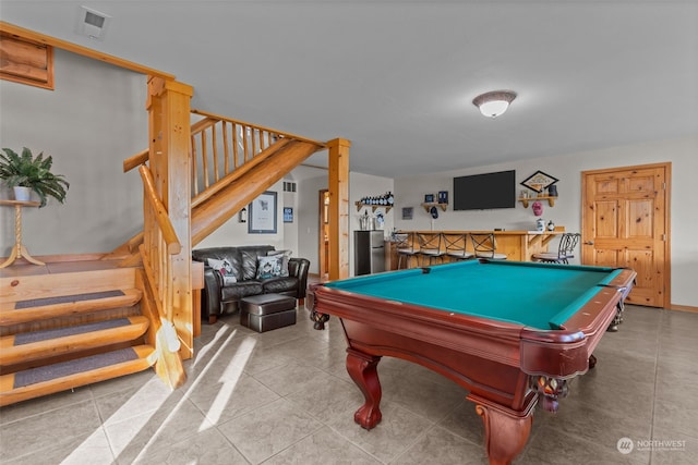 rec room featuring bar area, light tile patterned floors, and pool table