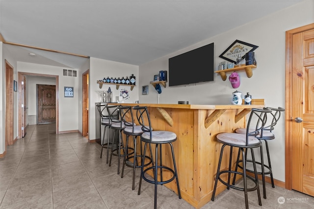 bar featuring tile patterned flooring