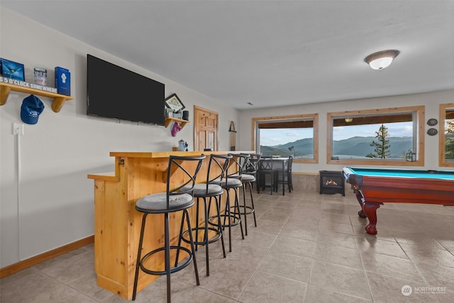 rec room featuring light tile patterned flooring, indoor bar, and pool table