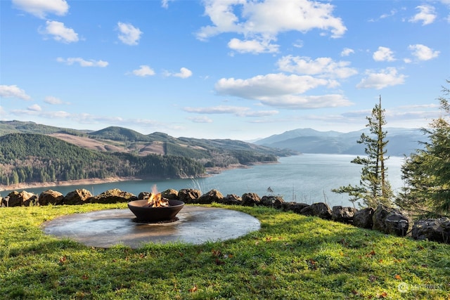 view of water feature with a mountain view and an outdoor fire pit