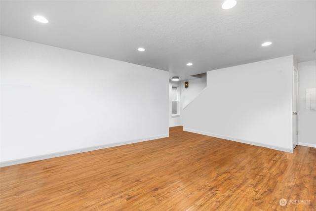 interior space featuring a textured ceiling and light wood-type flooring