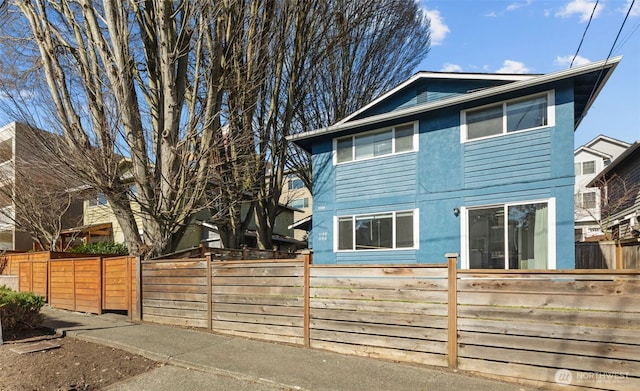 exterior space featuring fence private yard and stucco siding