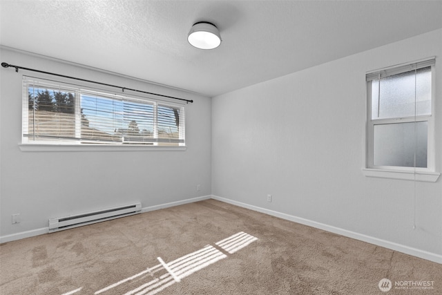 unfurnished room featuring baseboards, a textured ceiling, a baseboard heating unit, and carpet flooring