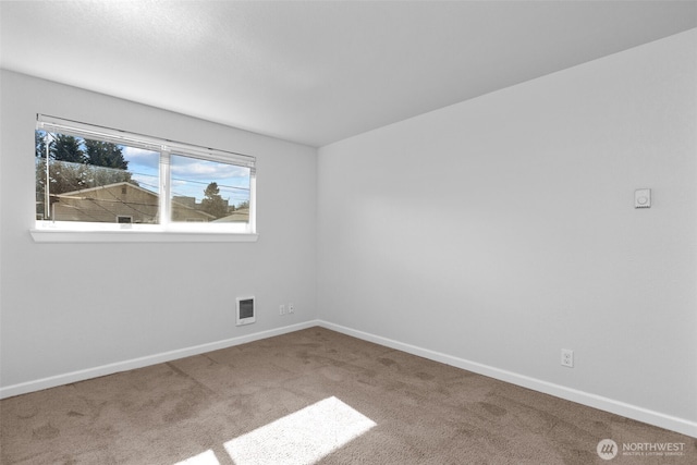 unfurnished room featuring carpet, visible vents, and baseboards