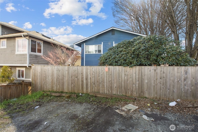 view of side of property featuring fence