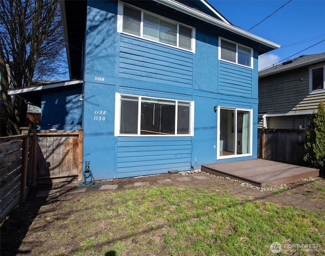 1128 N 91st St, Seattle, WA 98103 - back of property with a fenced backyard and stucco siding
