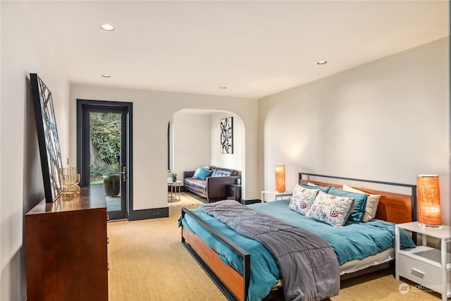 bedroom featuring access to exterior and light colored carpet