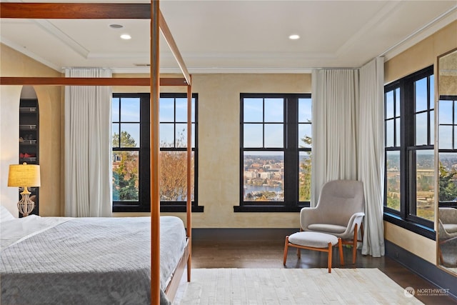 bedroom featuring ornamental molding and hardwood / wood-style flooring