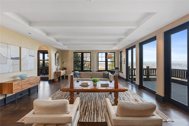 sunroom featuring beamed ceiling and plenty of natural light