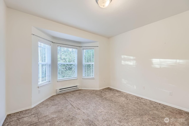 unfurnished room featuring baseboard heating and carpet