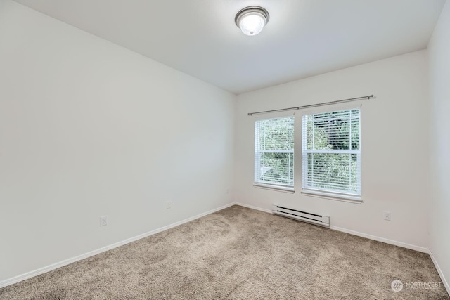 empty room with carpet floors and a baseboard heating unit