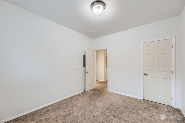 unfurnished bedroom featuring light colored carpet