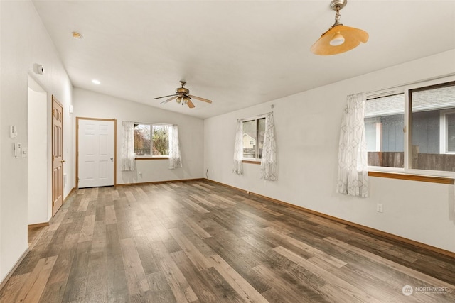 empty room featuring ceiling fan, lofted ceiling, and hardwood / wood-style flooring