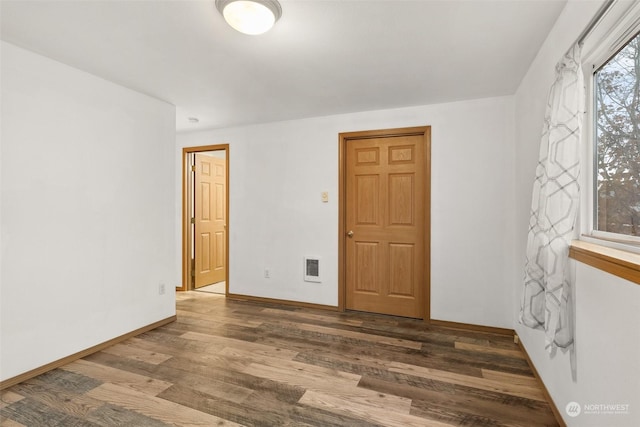 spare room featuring dark hardwood / wood-style floors