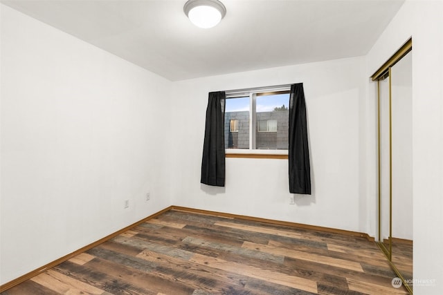 spare room featuring dark hardwood / wood-style flooring