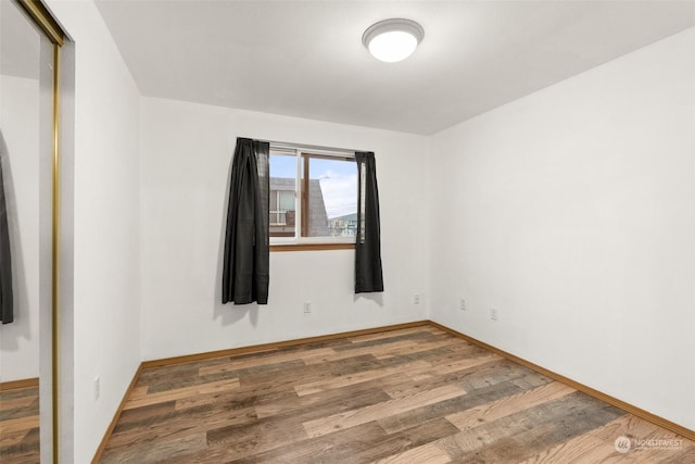 spare room with hardwood / wood-style flooring