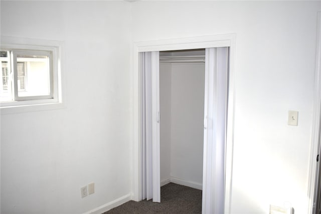 unfurnished bedroom with carpet and a closet