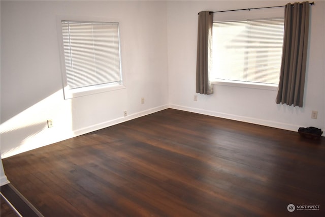 empty room featuring dark hardwood / wood-style flooring