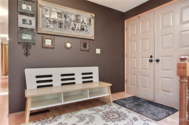 foyer featuring hardwood / wood-style floors and a textured ceiling