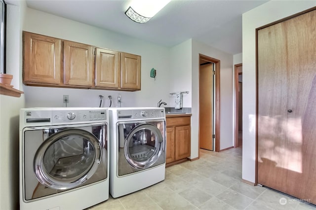 clothes washing area featuring cabinets, washing machine and dryer, and sink