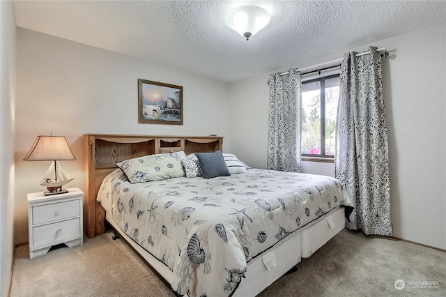 carpeted bedroom featuring a textured ceiling