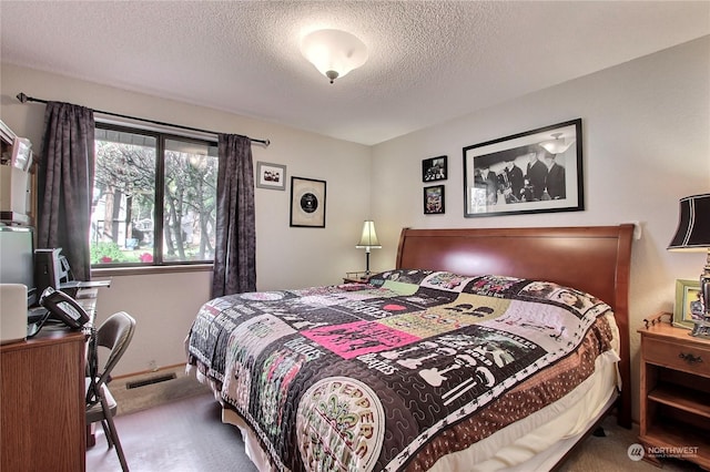 bedroom featuring carpet and a textured ceiling