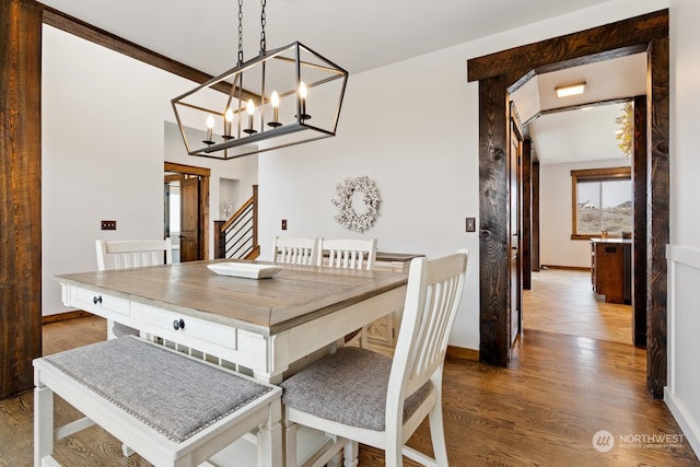 dining area featuring hardwood / wood-style flooring and a chandelier