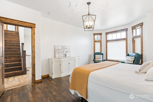 bedroom featuring dark hardwood / wood-style floors and a notable chandelier