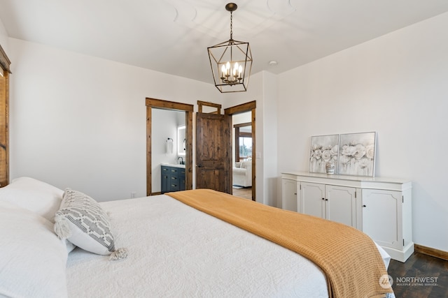 bedroom with dark hardwood / wood-style floors, an inviting chandelier, and ensuite bath