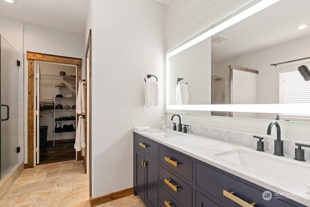 bathroom featuring vanity and a shower with shower door