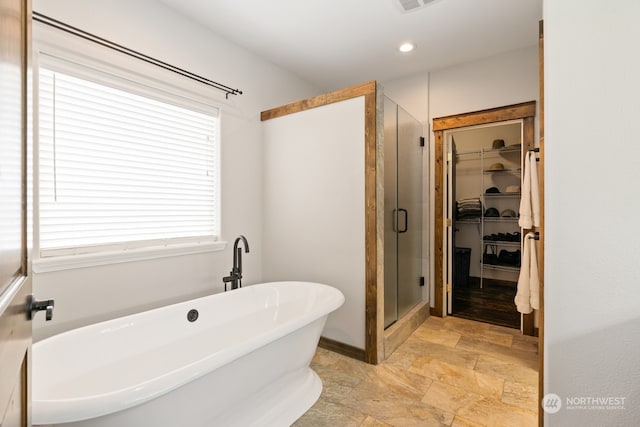 bathroom featuring independent shower and bath