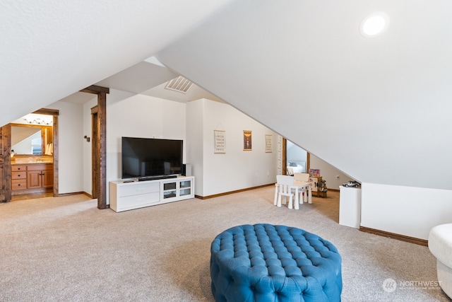 interior space with light carpet and vaulted ceiling