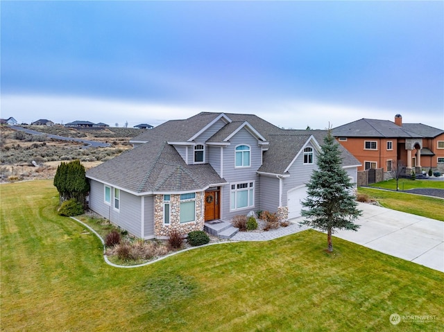 view of front of home with a front yard and a garage