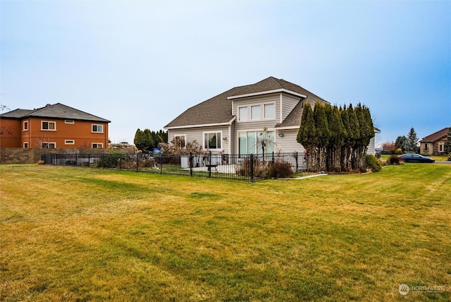 rear view of property featuring a lawn