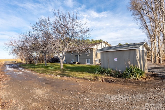 view of side of home with a yard