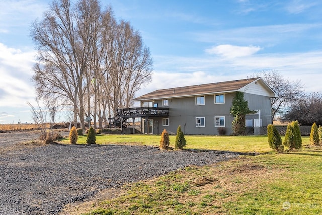 exterior space featuring a wooden deck and a yard