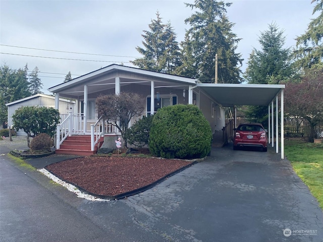 view of front of house featuring a carport and a porch