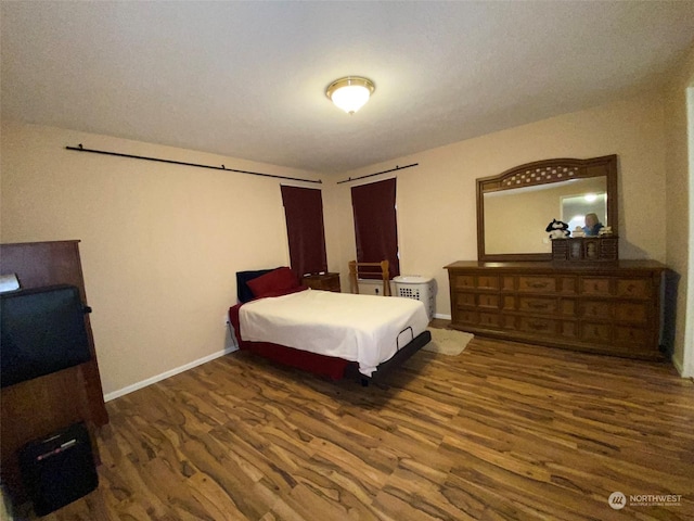 bedroom featuring dark hardwood / wood-style flooring