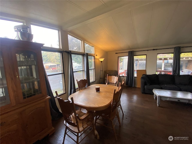 dining area featuring dark hardwood / wood-style flooring, lofted ceiling with beams, and plenty of natural light