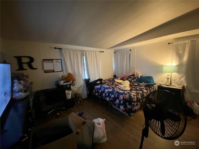 bedroom with wood-type flooring and vaulted ceiling