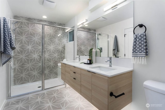 bathroom featuring toilet, vanity, and walk in shower