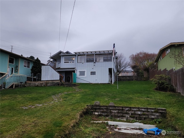 rear view of house with a lawn