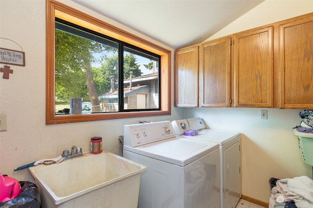 laundry room featuring cabinets, separate washer and dryer, and sink