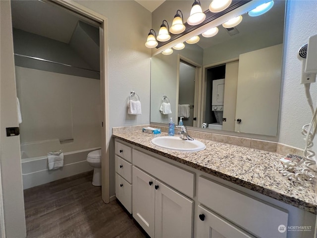 full bathroom with shower / bathing tub combination, hardwood / wood-style floors, vanity, and toilet