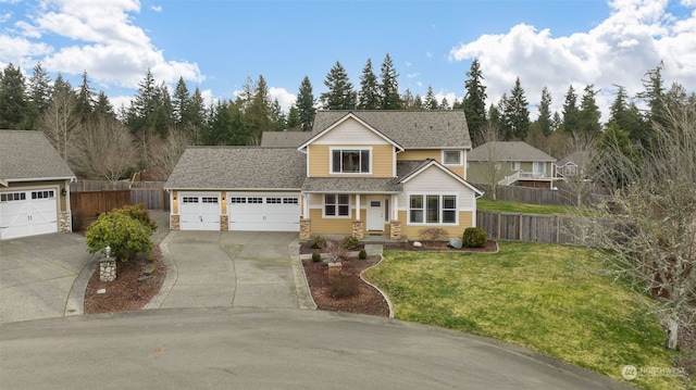 view of property featuring a front yard and a garage